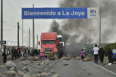 Supporters of former Peruvian President Pedro Castillo block the PanAmerican Highway in the town of La Joya, 1,000 kilometers south of Lima, to protest demanding his release and new elections in Lima
