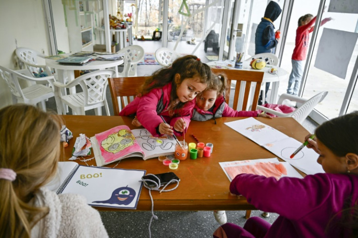 Refugee children draw in a Bulgarian Black Sea holiday camp, whose Russian owner has being putting up Ukrainian families