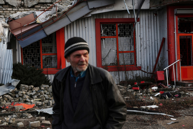 A man walks down by a damaged building, as Russia's attack on Ukraine continues, inside the war-torn formerly Russian occupied city of Lyman, Donetsk region of Ukraine
