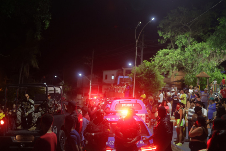 Police officers keep watch as supporters of Brazilian politician Roberto Jefferson demonstrate close to his house in Comendador Levy Gasparian