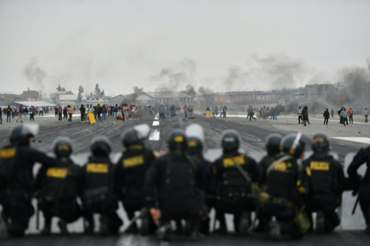 Protestors and riot police square off on a runway at Arequipa's airport in southern Peru