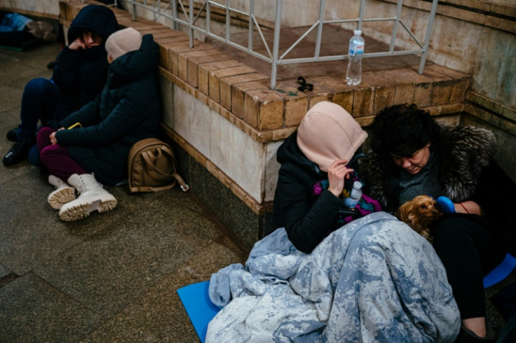Civilians take shelter inside a metro station during an air raid alert in the centre of Kyiv