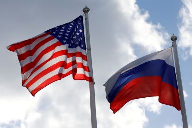 Russian and U.S. state flags fly near a factory in Vsevolozhsk