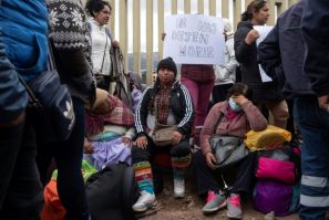 Passengers sit outside the entrance to the Alejandro Velasco Astete International Airport, in Cusco, Peru, on December 16, 2022
