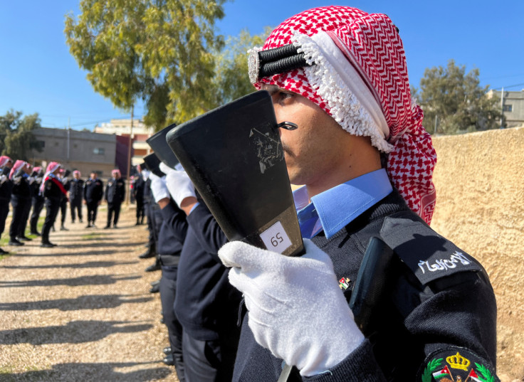 Jordanian security personnel attend the funeral of senior police officer who was killed in riots on Thursday night according to authorities