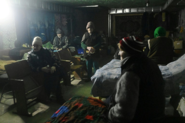 In one basic shelter, thick blankets and sleeping bags donated by volunteers are sprawled across eight beds