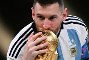 Lionel Messi kisses the World Cup trophy after leading Argentina to victory over France
