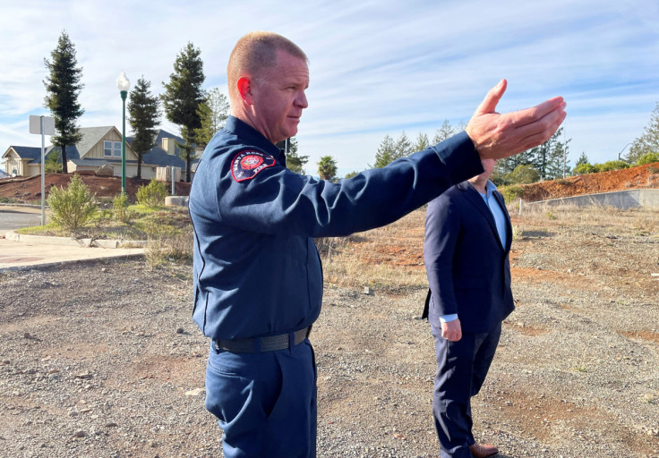 Fire Chief Scott Westrope gestures toward the empty lot where the previous office of Santa Rosa Fire Station 5 was destroyed in Santa Rosa