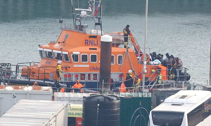 People believed to be migrants disembark a Royal National Lifeboat Institution (RNLI) lifeboat after being rescued from the English Channel while crossing from France, in Dover