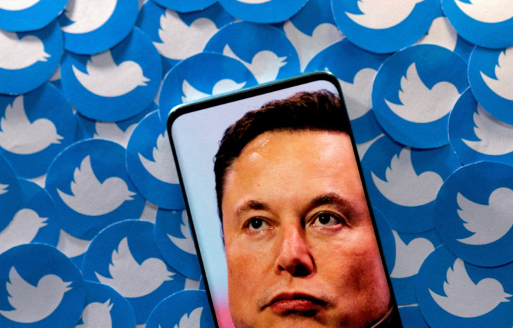 Illustration shows Elon Musk image on smartphone and printed Twitter logos