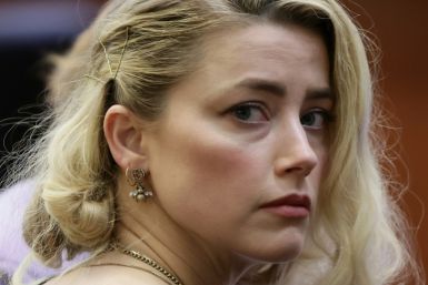 Actress Amber Heard says she has reached a settlement in the defamation case brought against her by her ex-husband Johnny Depp