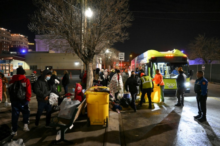 After El Paso's mayor declared a state of emergency, workers in the Texas border city offer services in freezing temperatures to an encampment of migrants near a bus station who had recently crossed into the United States from Mexico