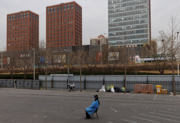A security guard keeps watch outside a makeshift fever clinic that was set up in a sports area as COVID-19 outbreaks continue in Beijing