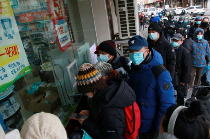 People queue to buy medicine at a pharmacy amid the Covid-19 pandemic in Nanjing, in China's eastern Jiangsu province