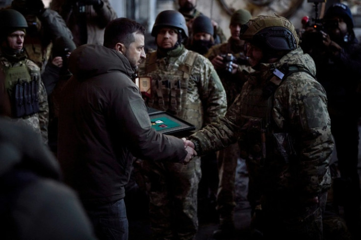 Ukrainian President Volodymyr Zelensky hands out awards during his visit in the eastern frontline city of Bakhmut -- he is now expected to head to the United States