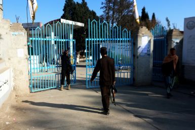 Armed guards at the gates of a university in Jalalabad a day after the Taliban banned women from tertiary education