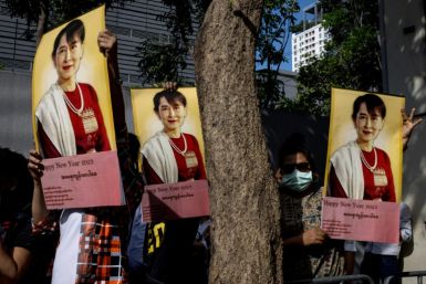 Burmese protesters hold up pictures of detained Myanmar civilian leader Aung San Suu Kyi