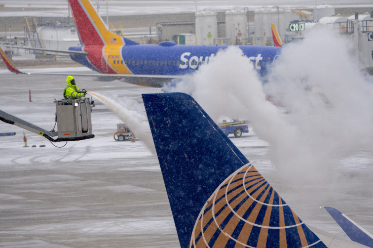 Ice is removed from a United Airlines jet at General Mitchell International Airport in Milwaukee