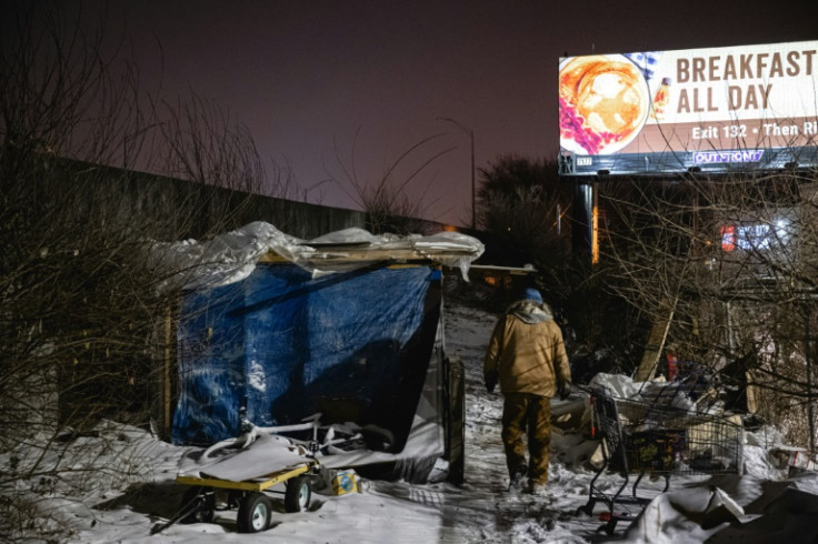 An outreach worker delivers supplies to people living in a homeless camp on December 23, 2022 in Louisville, Kentucky, as a major storm hammers US communities with temperatures 40 degrees below average ahead of the Christmas holiday