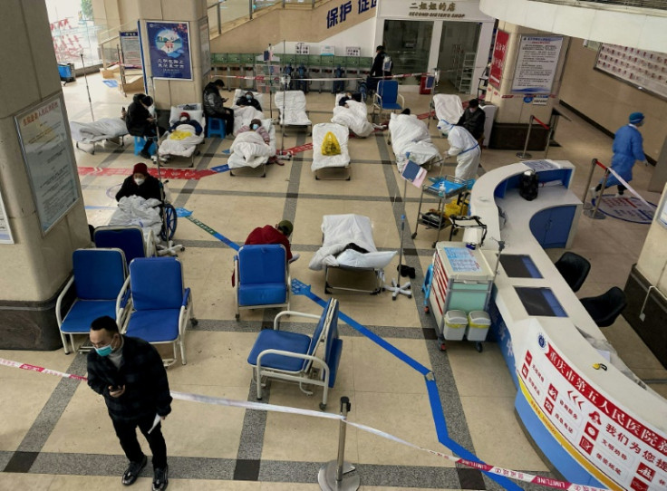 Covid-19 patients lie on hospital beds in a cordoned off area in the lobby of the Chongqing No. 5 People's Hospital in China's southwestern city of Chongqing on December 23, 2022