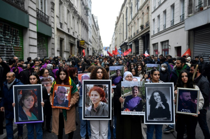 Several hundred people marched in Paris on Monday to remember the shooting victims.
