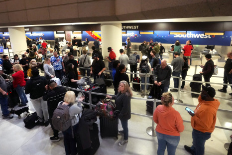 People wait in long lines for the Southwest Airlines check-in counters at Phoenix Sky Harbor International Airport