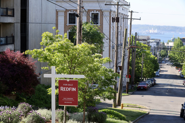 A "For Sale" sign is posted outside a residential home in Seattle