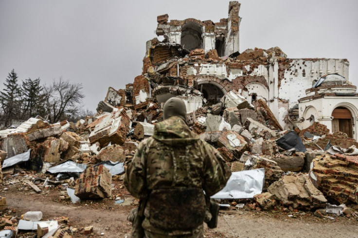 Caesar, a 50-year-old Russian who fights on the side of Ukraine, walks through the ruins of an Orthodox monastery in Dolina