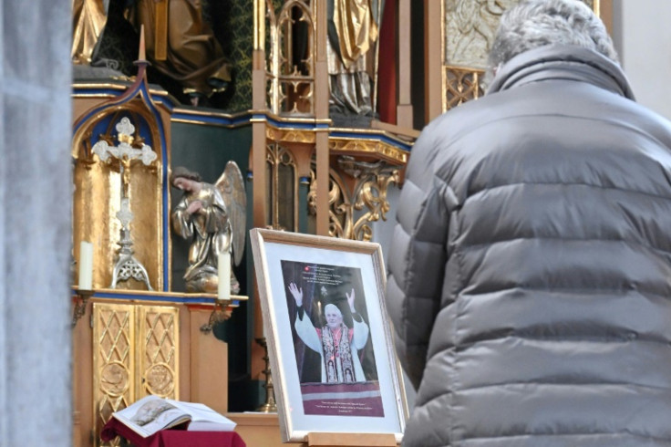 A handful of faithful in  Regensburg braved the early cold to attend mass at the cathedral, where a large portrait of the pope emeritus sits on the altar