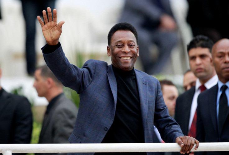Brazilian soccer legend Pele waves during the international friendly soccer match between Algeria and Slovenia in Algiers