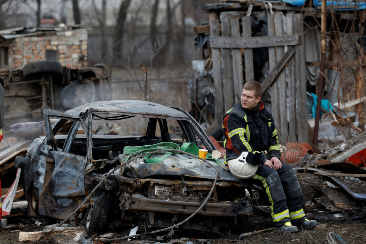 Rescuer rests at a site damaged during a Russian missile strike, in Kyiv