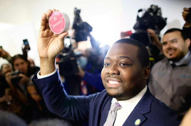 Chris Alexander, head of New York's Office of Cannabis Management, holds up cannabis jelly beans at the opening of the city's first cannabis boutique