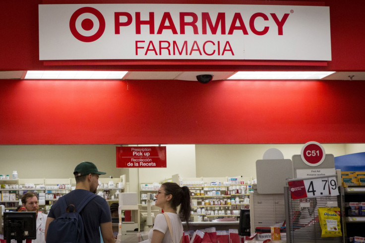 Customers wait in line in the pharmacy department at a Target store in the Brooklyn borough of New York