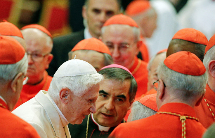 Pope Emeritus Benedict XVI is greeted by Cardinals as he arrives to attend a consistory ceremony in Saint Peter's Basilica at the Vatican