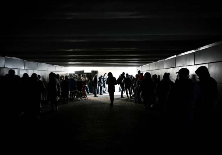 People shelter in an underground pedestrian crossing during missile strikes in Kyiv on New Year's Eve