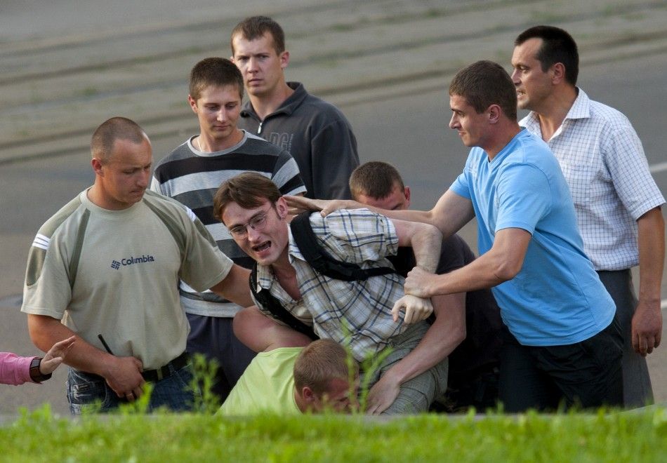Belarusian policemen in plainclothes detain a man