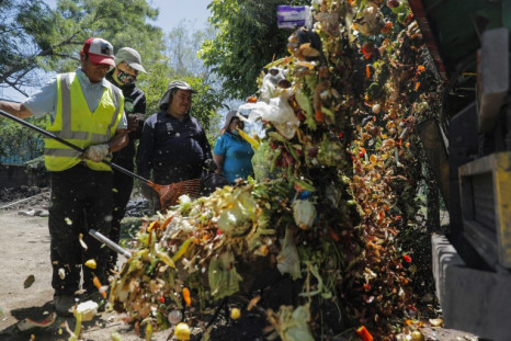 Municipal staff collect organic material to be sent for a vermiculture recycling process in the commune of La Pintana in Santiago, Chile
