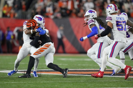 Damar Hamlin (L) of the Buffalo Bills collapsed to the ground soon after tackling Tee Higgins of the Cincinnati Bengals in the first quarter of their NFL game on January 2, 2023