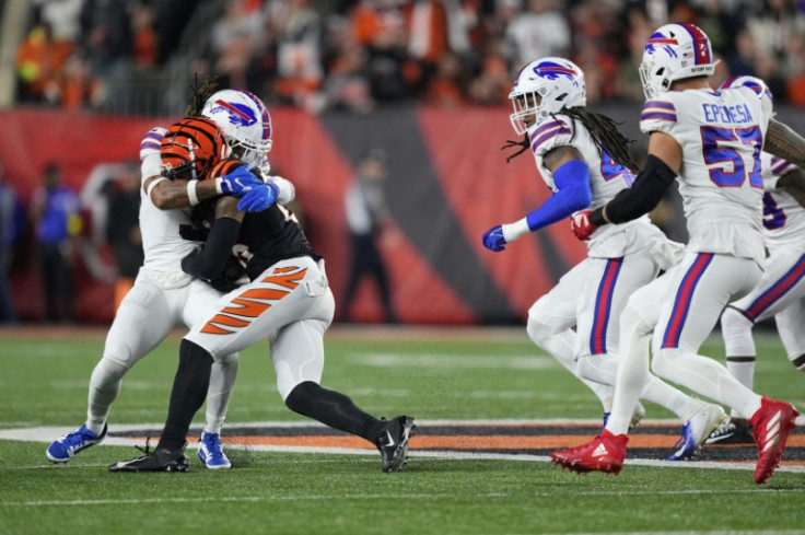 Damar Hamlin (L) of the Buffalo Bills collapsed to the ground soon after tackling Tee Higgins of the Cincinnati Bengals in the first quarter of their NFL game on January 2, 2023