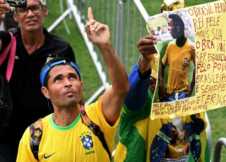 Fans lined up to pay tribute to Pele as they filed past the football great's coffin at the Vila Belmiro stadium, home to his longtime club, Santos FC