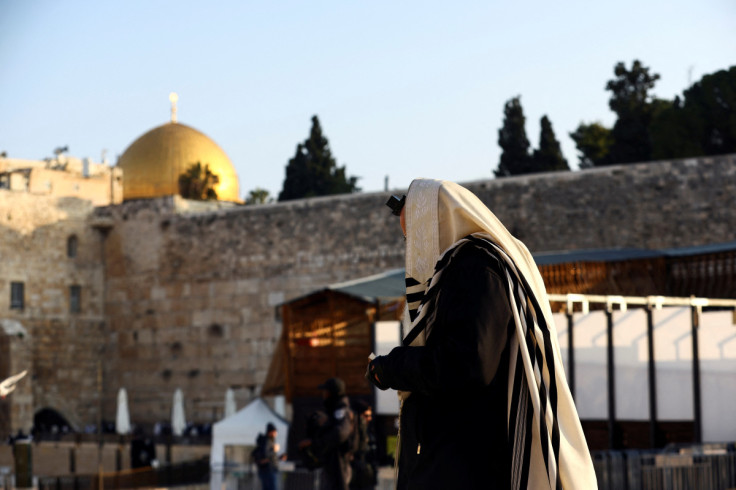 An Orthodox Jewish man walks next to the Western Wall, Judaism's holiest prayer site, near the compound known to Muslims as Noble Sanctuary and to Jews as Temple Mount, in Jerusalem's Old City
