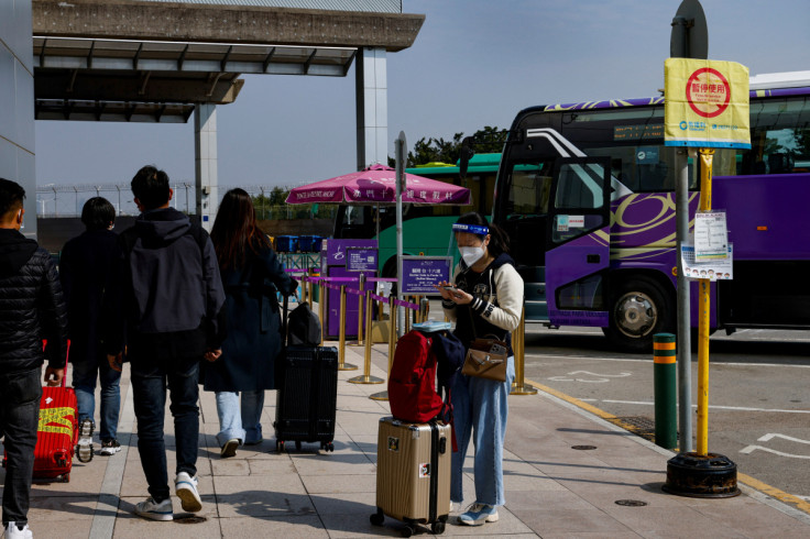 Chinese travellers wear face masks outside the border checkpoint with the neighbouring city of Zhuhai, in Macau