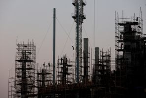 Labourers work at the construction site of a commercial building in New Delhi