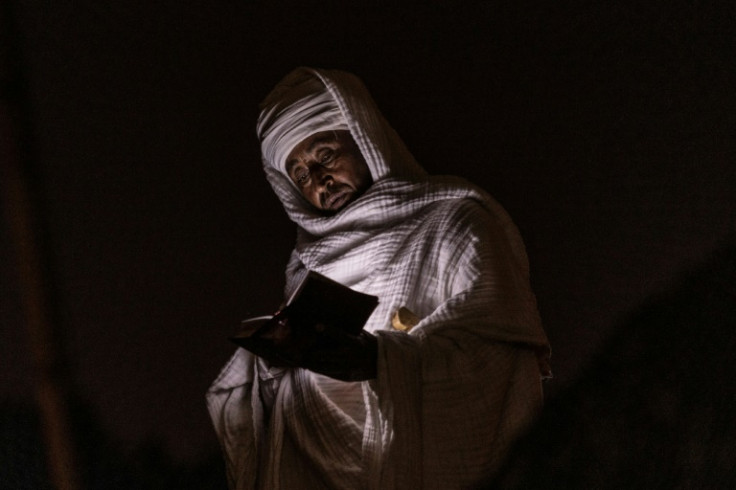 A pilgrim reads the Bible during the celebrations in one of Ethiopia's holiest places