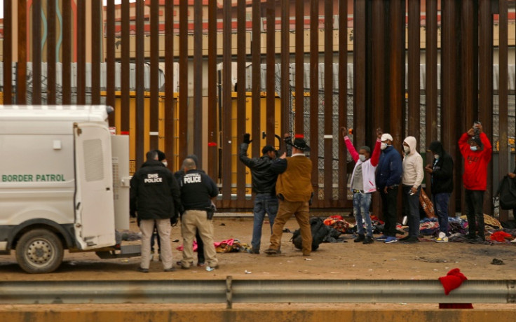Migrants seeking asylum in the United States turn themselves in to Border Patrol agents after crossing over from Mexico