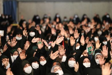 Women wave during an address by Iran's supreme leader Ayatollah Ali Khamenei