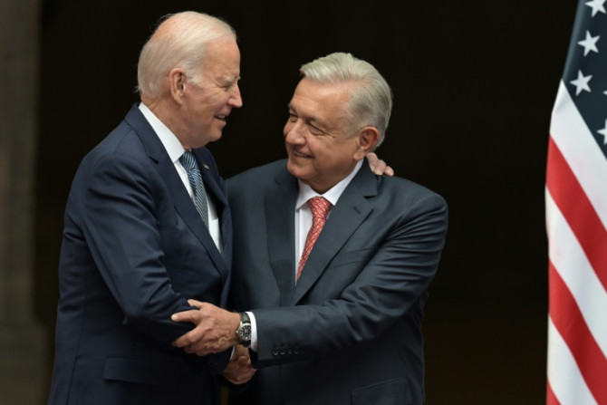 US President Joe Biden shakes hands with his Mexican counterpart Andres Manuel Lopez Obrador during a welcome ceremony at the National Palace in Mexico City