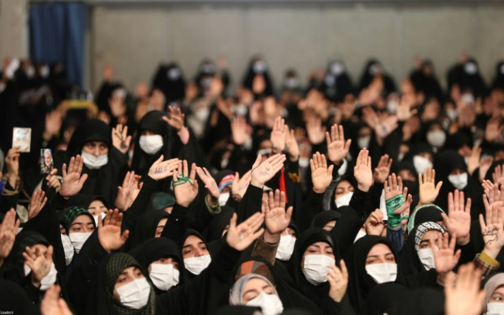 Women wave during an address by Iran's supreme leader Ayatollah Ali Khamenei