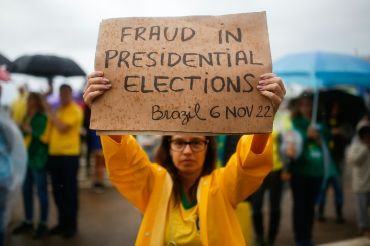 A protester holds up a sign alleging 'fraud' in the Brazilian presidential vote