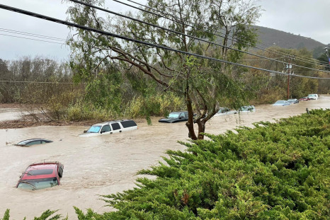 Cars are seen submerged in flood waters in Morro Bay